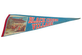 Angled view of the blue felt Black Creek Village pennant, showing its vintage graphic and red text.