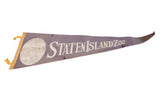 Angled view of the vintage Staten Island Zoo pennant's faded purple felt and cream graphics.