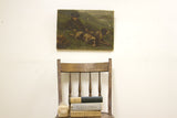 Antique oil painting of a young boy and two hunting dogs in a green landscape.
