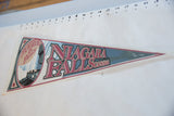 Angled view of the vintage Niagara Falls felt pennant displaying its full length and graphic design.