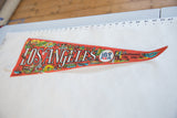 Vintage Los Angeles felt pennant with bold 'ANGELES' text and colorful city art.
