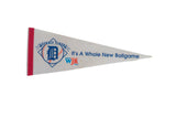 Off-white vintage Detroit Tigers felt pennant with blue text, logo, and a red stitched border.