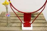 Industrial accent basketball hoop, chippy red metal and white bolted base.