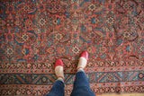 Detailed view of the allover herati motif and complex floral borders on an antique Persian Bakshaish rug.