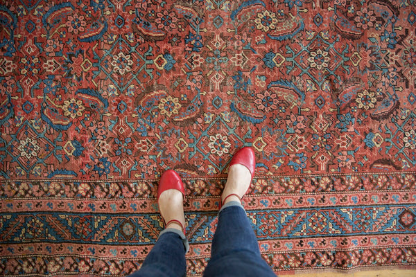 Detailed view of the allover herati motif and complex floral borders on an antique Persian Bakshaish rug.