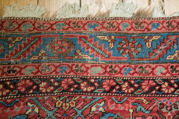 Close-up of the border on an antique Bakshaish rug, showing Caucasian-style floral motifs and fringe.