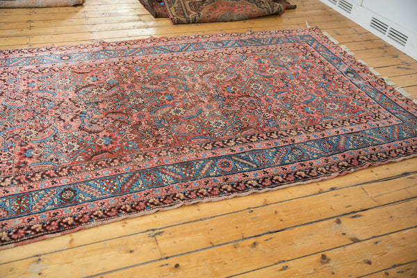 Angled view of the antique Persian Bakshaish rug highlighting its allover herati pattern.