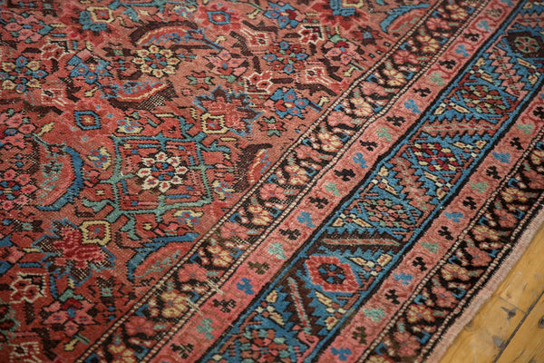 Close-up of an antique Bakshaish rug showing the intricate herati pattern and floral borders.
