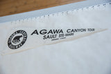 Time-softened white felt pennant displaying 'Agawa Canyon Tour' and railway logo.