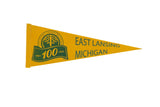 A vintage East Lansing Michigan felt pennant in yellow with green centennial graphics.