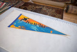 Sea World felt flag pennant laid out next to a measuring guide.