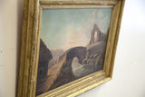 Angled view of the antique landscape painting's thatched cottage, stone bridge, and distressed gold frame.