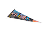 Angled view of a vintage Chicago felt pennant with retro multicolored graphics.