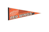 Vintage Detroit Red Wings felt pennant, orange with white winged wheel logo and black text.