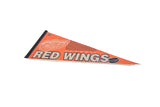 Vintage Detroit Red Wings felt pennant featuring 'RED WINGS' text and hockey puck graphic.