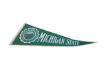 Vintage Michigan State University pennant, showing felt creasing and discoloration along white trim.