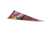 Close-up of vintage New Jersey Devils felt pennant, showing 'NEW JERSEY' text and logo detail.