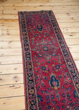 Unique blue shadow medallion on rich cranberry and fuchsia Sarouk runner.