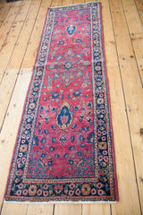 Corner of Sarouk runner with unique blue spandrel, fuchsia-toned cranberry field, and floral border.