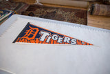 Vintage Detroit Tigers pennant shown flat next to a ruler for scale.