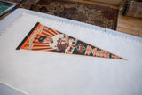 Angled view of the vintage Cal Ripken Jr. Orioles pennant laid beside a ruler showing its scale.