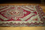 Tattered red, ivory, and minty blue tribal motif of an antique Anatolian rug.