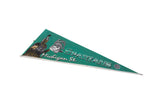 Angled view of the green felt Michigan State Spartans pennant, showing its full length and graphics.