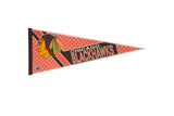 Vintage Chicago Blackhawks felt pennant with classic logo on a red diamond-patterned background.