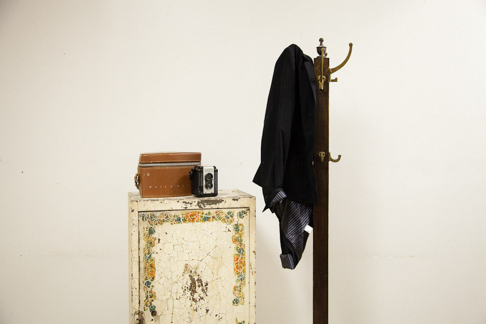 Vintage shabby industrial metal cabinet with a chippy white finish and painted floral border.