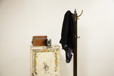 Vintage shabby industrial metal cabinet with a chippy white finish and painted floral border.