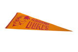 Vintage Albuquerque Dukes orange felt pennant, showing red mascot and lettering, with subtle curve.