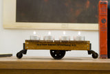 Reclaimed mahogany mini cart side view featuring Old New House branding with four lit tea lights.