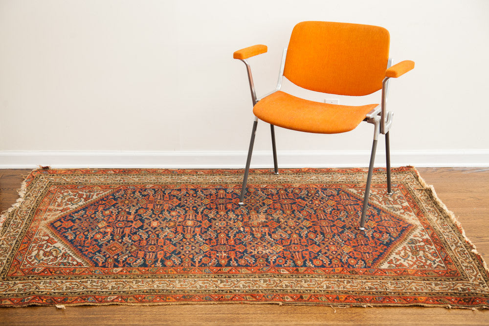 Tattered vintage Hamadan tribal rug, indigo blue, red, and cream geometric patterns, 4'3" x 6'3".