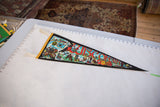 Vintage Wisconsin felt pennant with vibrant state symbols and bold 'WISCONSIN' text.