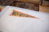 Vintage Sault Ste. Marie felt pennant laid next to a ruler to show its full scale.