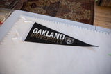 Vintage Oakland University felt pennant, black with white and gold text and bear logo, 9