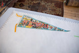 Vintage Michigan felt pennant showing orange lettering, state map, and yellow ties.