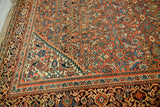 1930s Persian Hamadan rug corner, softened burnt orange Herati motif and tribal border.