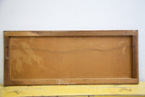 Back of the vintage oil painting showing the masonite board, wood frame, and hanging wire.