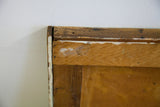 Detailed view of the vintage painting's aged wooden frame with signs of chipping and wear.