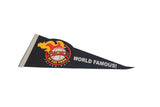 Close-up on the vintage pennant's logo showing a baseball with red and yellow flames.