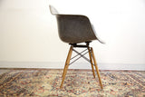 Elephant grey Eames PAW swivel chair side, showcasing rope edge and fiberglass texture.