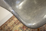 Eames PAW chair's textured elephant grey fiberglass shell with distinct rope edge.