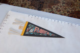 Vintage Florida felt pennant's left side with yellow binding, white ties, and hanging tab.