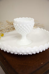 White hobnail milk glass goblet base and scalloped bowl rim.