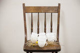 A set of twelve milk glass punch cups with an intricate swirl design and dainty handles.