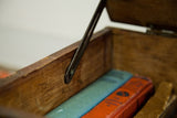 Aged wood interior and unique metal hinge of the antique Rascal trunk.