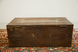 Antique Rascal Trunk's right side, revealing dark wood patina and painted 'Rascal' art.