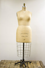 Lower section of vintage dress form with 'Model 1969 38' and cast iron base.