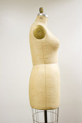 Lower section of the vintage Wolf dress form, featuring aged linen and wire cage.